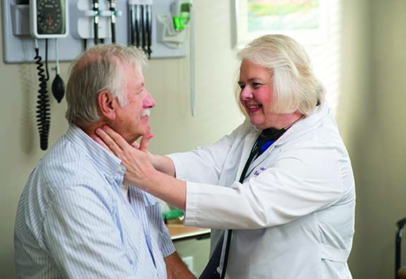 Doctor taking care of her elderly patient