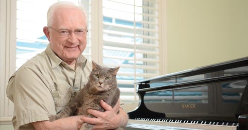 The old man happy with his cats.