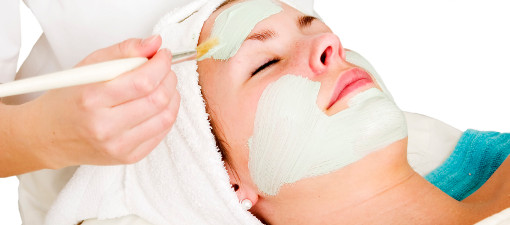 A detail image of a green apple mask being applied at a beauty spa.