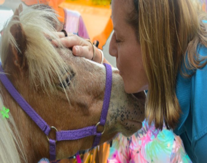 Woman kissing the horse