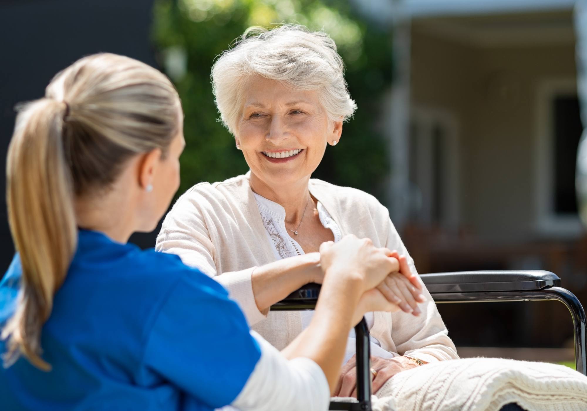 An elderly woman in the care of a nurse