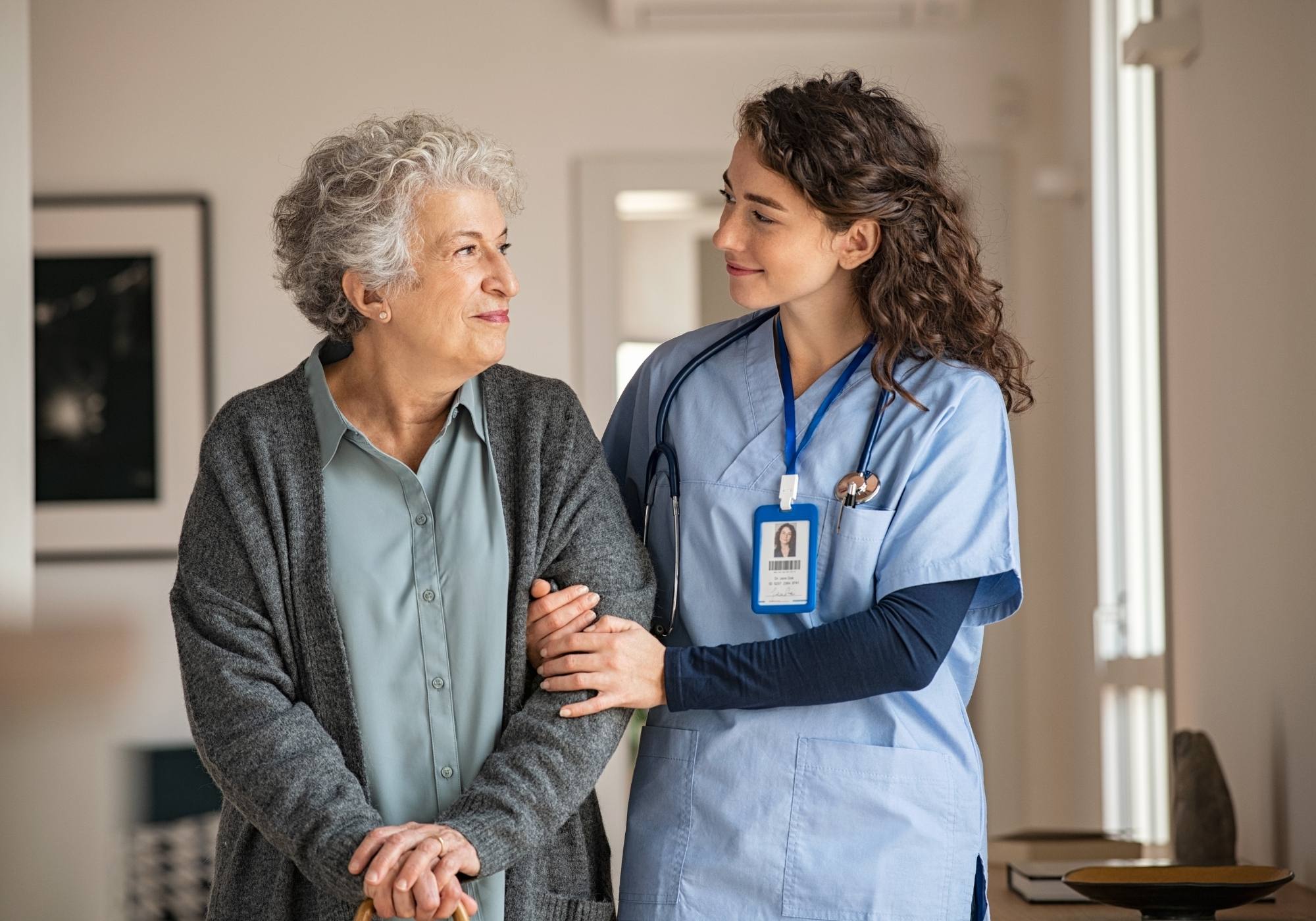 An elderly woman in the care of a nurse