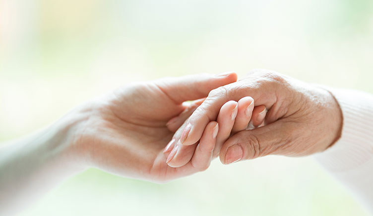 A photo of a pair of hands against a light backdrop