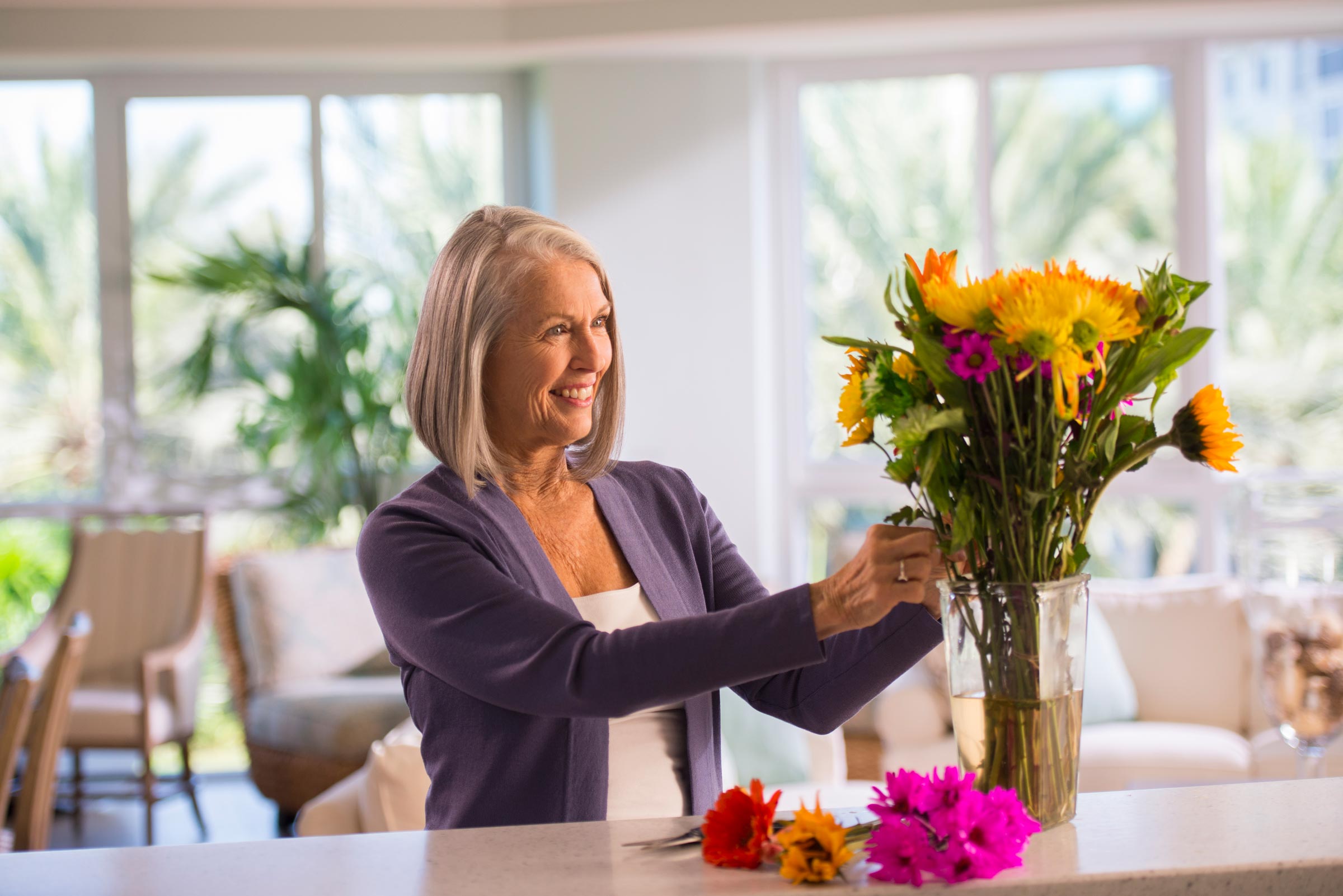 The women arrange flowers in dining table at Myers, FL