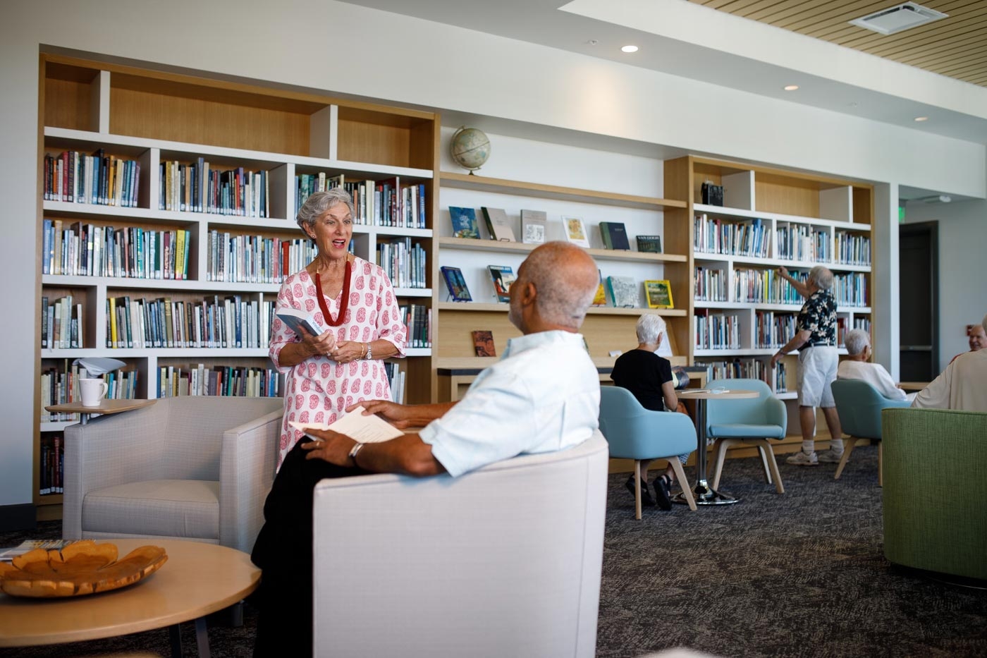 Two people talking about artists in the Literary Loung inside The Tribby Arts Center