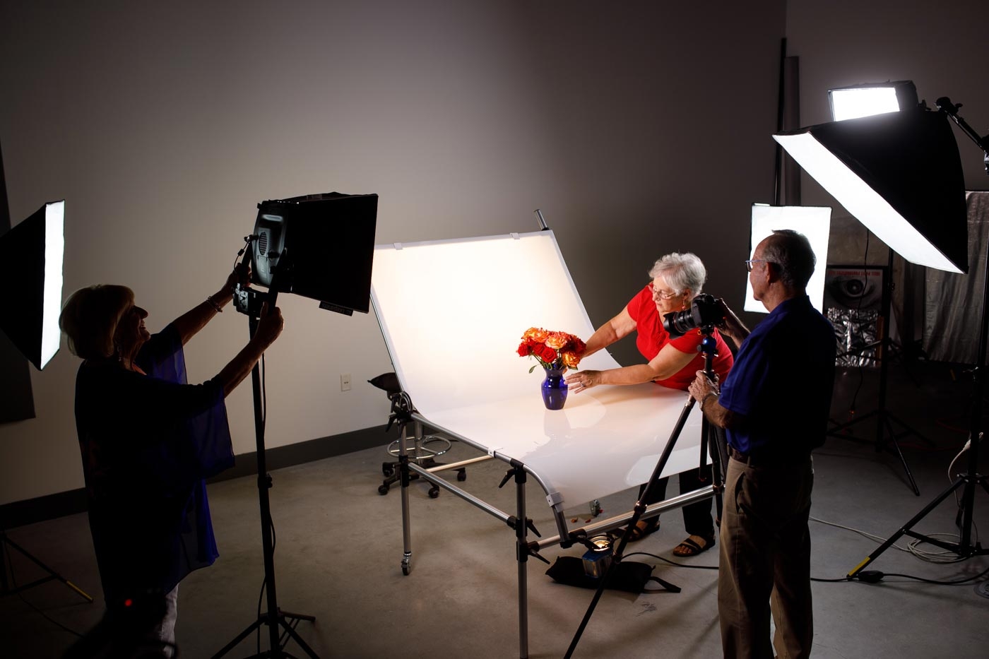 Positioning a vase of colorful flowers for a photo shoot